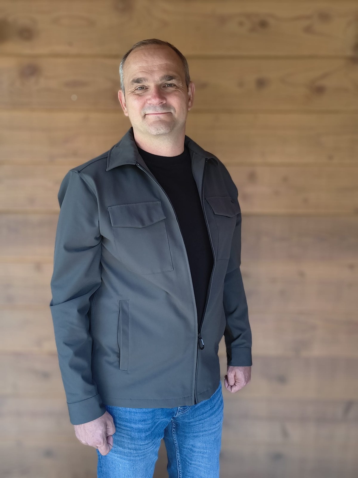 Klaas Jan Hommes voor een houten wand